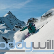 New Logo overlaid on photo of Roddy Willis skiing in Verbier