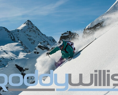 New Logo overlaid on photo of Roddy Willis skiing in Verbier
