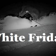 Ski instructor carving down a snowy alpine slope during early-season conditions in Verbier