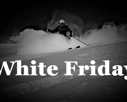 Ski instructor carving down a snowy alpine slope during early-season conditions in Verbier