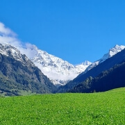 Autumn in Verbier with snow-covered mountain tops, showcasing a beautiful contrast of fall foliage and early winter snow in the Swiss Alps."