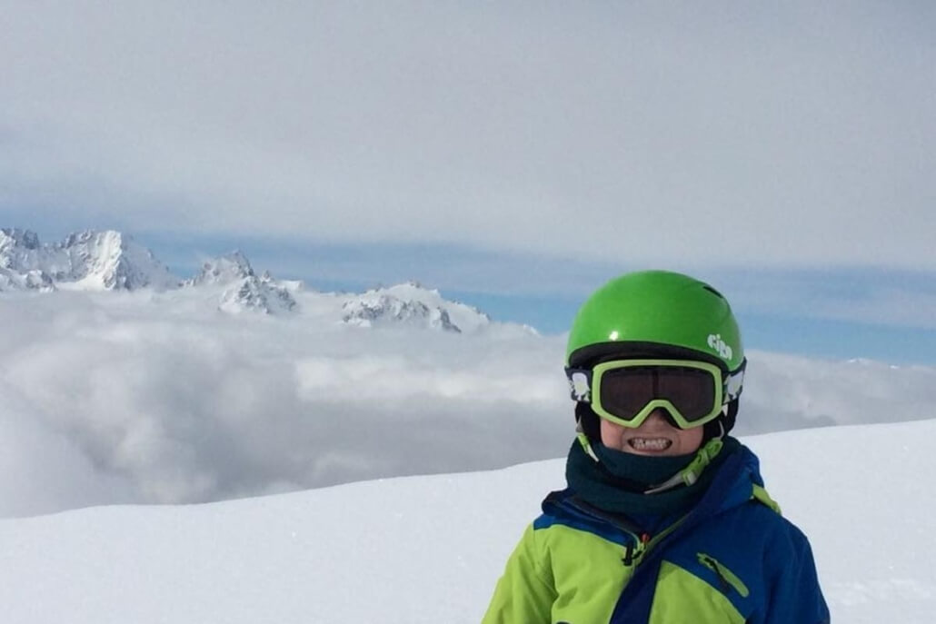 Beginner Ski Lesson in Verbier Child smiling during beginner ski lesson in Verbier with confidence on gentle terrain