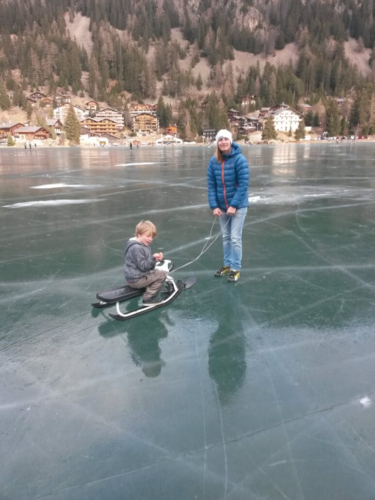 Frozen ChampChampex-Lac Winter Lake Scene Child on sled being pulled across the frozen lake at Champex-Lac in the Swiss Alps