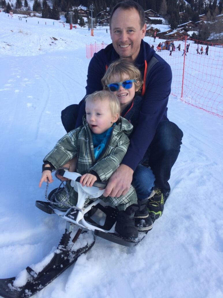 Tobogganing in Verbier Switzerland Family tobogganing on the snow in Verbier Switzerland winter sledging activity
