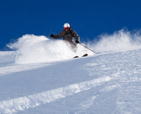 Advanced skier skiing powder snow in Verbier during a private coaching session
